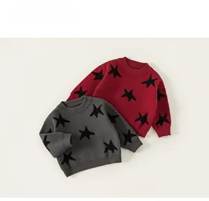 Detailed view of kids star pattern knitted sweaters with ribbed cuffs in grey and red
