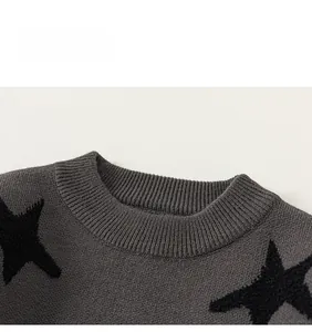 Close-up of dark grey boys knitted sweater with ribbed crew neck and black star pattern