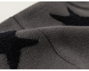 Macro shot of gray knitted cotton fabric with a plush black star embroidery detail