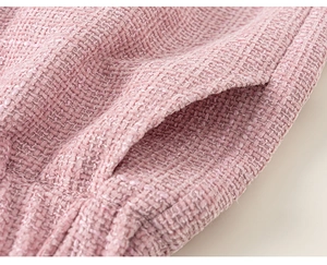 Close-up of pink tweed fabric texture and pocket detail for girls three-piece set