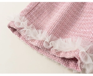 Detail of pink tweed fabric with silver glitter threads and white mesh pleated edges