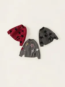 Three children's zip-up knit sweaters in burgundy and grey with star patterns
