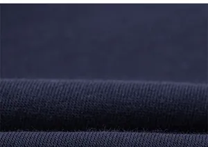 Gros plan sur la texture du tricot bleu foncé montrant les fibres douces et le tissage