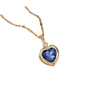 Elegant gold titanium necklace with blue heart sapphire pendant and dainty white diamond