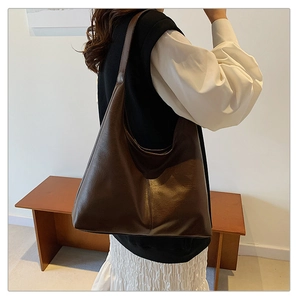 Side view of a model wearing the dark brown large capacity tote bag for daily commute