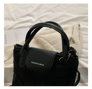 Close-up of comfortable round handle and black quilted fabric detail on fashion tote bag