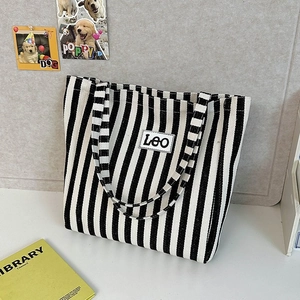 Detailed view of the large capacity canvas tote bag with black and white vertical stripes