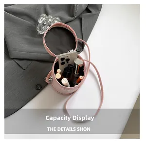 Capacity display of the pink leather bucket bag showing phone and cosmetics inside