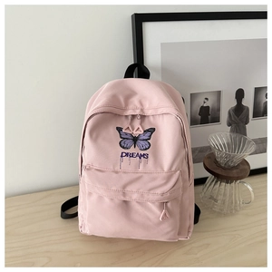 Detailaufnahme des rosa Nylon-Rucksacks mit lila Schmetterlingsdruck und DREAMS Text