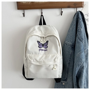 Nahaufnahme des weißen Rucksacks mit violettem Schmetterling und Dreams-Aufdruck