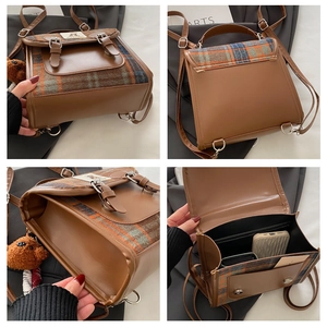 Detail view of plaid woolen backpack showing interior pockets and metal buckle hardware
