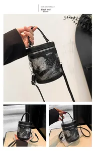 Detail of black bucket bag with silver butterfly embroidery and branded lettering