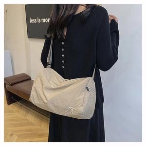 Détail du sac cabas en nylon beige montrant la texture plissée et le logo FY