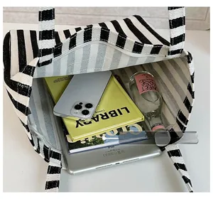 Top view of large canvas tote bag showing interior space with iPad, books and water bottle