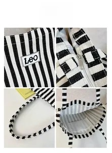 Detail view of striped canvas tote featuring metal zipper and reinforced shoulder straps