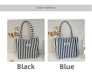 Detail view of canvas tote bags with blue and black vertical stripes and LEO patch