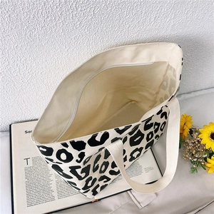 Detailed top view of wide leopard print canvas tote bag with spacious beige interior lining