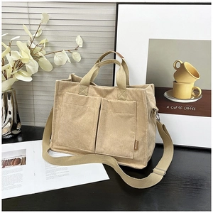 Large khaki corduroy tote bag with dual front pockets and adjustable shoulder strap