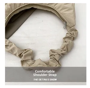 Close-up of beige ruched shoulder strap showing soft cloud-like pleated fabric detail