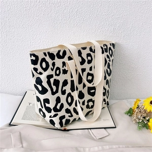 Detail shot of canvas leopard print tote bag with durable off-white fabric handles