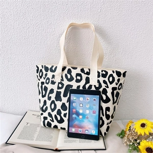 Pink leopard print canvas tote bag shown with a tablet to demonstrate its large capacity