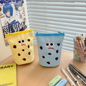 Detail of cute embroidered cartoon canvas pen pouches in bright yellow and sky blue