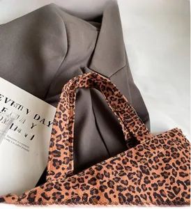Close-up of leopard print tote bag with durable stitching details on canvas material