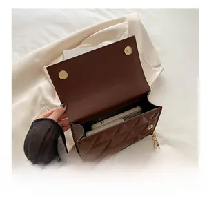 Detailed interior view of the brown quilted handbag showing phone and wallet capacity
