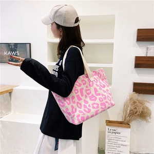 Detail view of pink leopard print canvas tote bag with spacious interior and soft handles