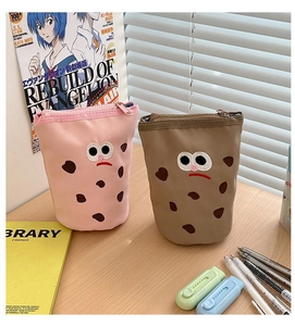 Close-up of pink and brown canvas pen bags with cute cartoon embroidery and zip closure