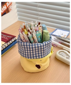 Detail of a large capacity cylinder canvas pen holder with cartoon bear embroidery