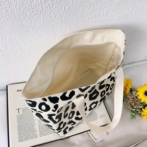 Detail view of the zipper closure and spacious interior of the pink leopard canvas tote bag