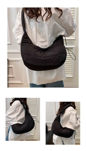 Detail of black quilted cloud bag showing the textured fabric and chic ruched shoulder strap
