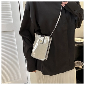 Vertical silver crocodile pattern phone bag with metallic finish and gold buckle