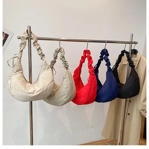 Detail view of colorful ruched hobo bags on display showing various spring color options