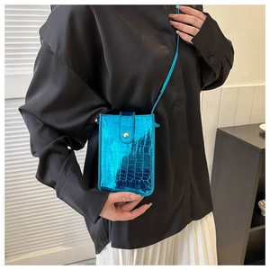 Detail of blue metallic faux crocodile texture on a stylish mini crossbody phone bag