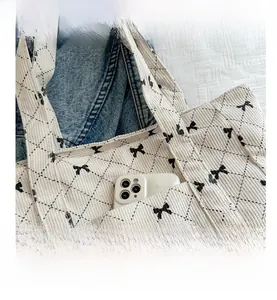 Detail of corduroy tote bag showing front pocket with phone for storage utility