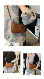 Detail view of brown lychee pattern crescent bag with silver buckle and adjustable strap