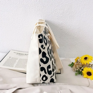 Detail showing the thick canvas texture and black leopard print on this stylish tote bag