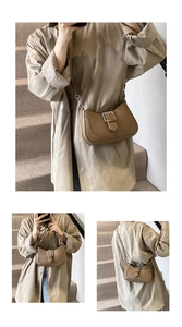 Detail view of brown pebbled leather crescent crossbody bag with metallic buckle closure