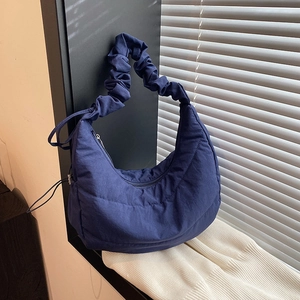 Navy blue quilted hobo bag with cloud-style pleated shoulder strap in soft fabric