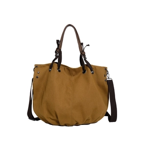 Retro mosterdgele canvas tas met donkerbruine leren handvatten en schouderband