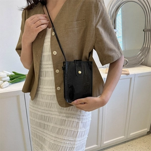 Glossy black croc-effect vertical phone bag with gold clasp and slim shoulder strap