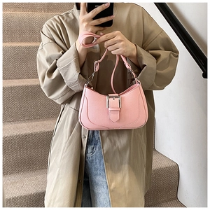 Pink litchi grain crescent bag with silver metal buckle and adjustable strap detail