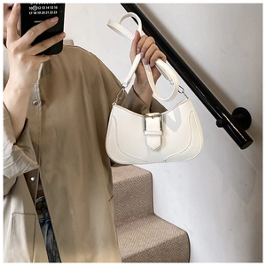 Close-up of white lychee pattern leather shoulder bag with silver buckle and stitch detail