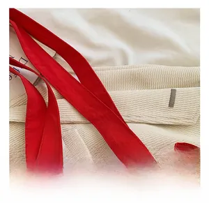 Close-up of comfortable wide shoulder strap and pleated edge on red nylon bucket bag