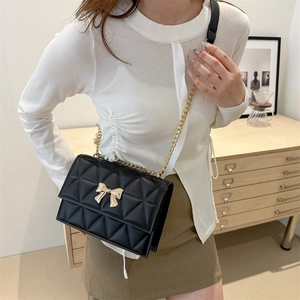 Classic black quilted crossbody bag for women with gold bow buckle and chain strap