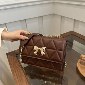 Deep brown quilted crossbody bag with golden bow clasp and metal chain strap
