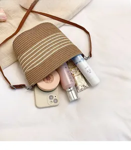 Detailed interior of striped woven straw bucket bag showing spacious storage capacity