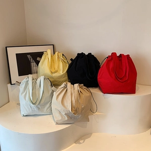 Minimalist nylon bucket bags with drawstring closure in five assorted colors for women